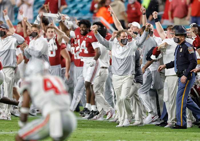 Nick Saban raises his hands in celebration on the sideline